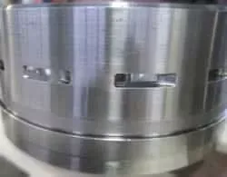 Disc centrifuge bowl body with sludge ports